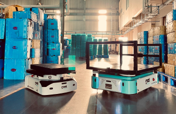 An automated warehouse filled with boxes is set up, along with a robotic assistant moving them.